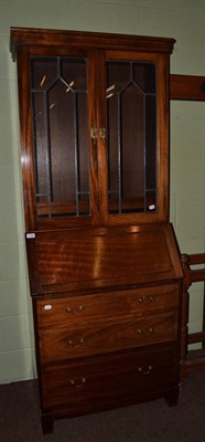 Lot 1376 - A bureau bookcase with lead glazed upper section