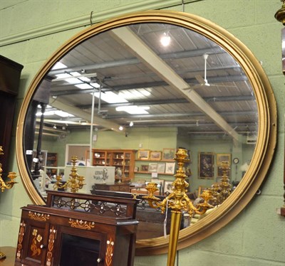 Lot 1391 - A large gilt framed oval mirror