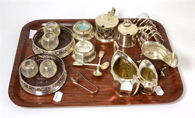 Lot 1 - A group of silver including a six division toast rack, two decanter labels, matching cream and...