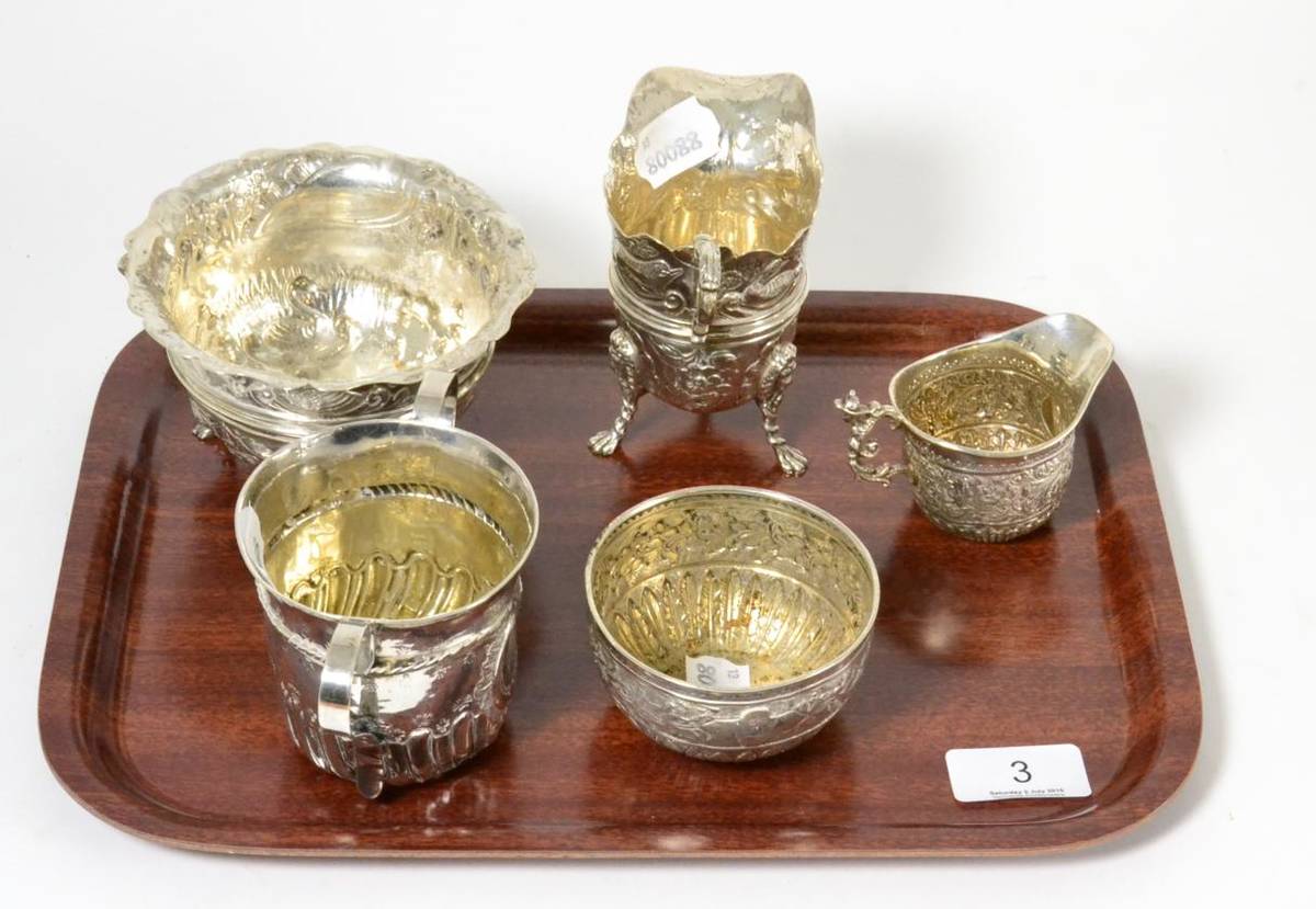 Lot 3 - A group of silver including a sugar bowl, matching cream and sugar, helmet form cream jug and a...