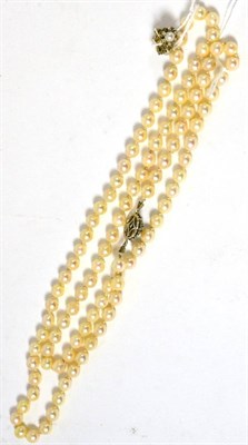 Lot 69 - A cultured pearl necklace with a sapphire set clasp and a pair of cultured pearl and diamond...