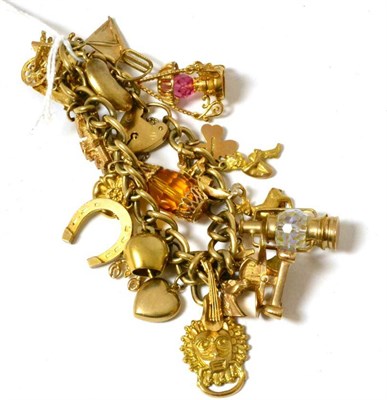 Lot 80 - A 9ct gold charm bracelet hung with 24 charms