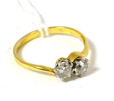 Lot 83 - An 18ct gold two stone diamond ring in cross over setting, total estimated diamond weight 0.5 carat
