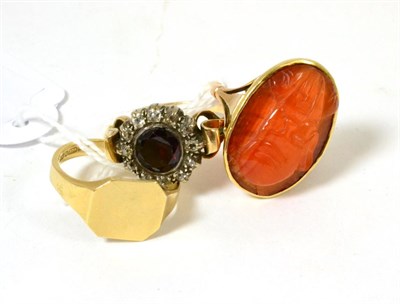 Lot 90 - A garnet and diamond cluster ring, a carved cornelian (?) ring and a 9ct gold signet ring (3)