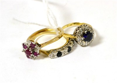 Lot 92 - A 9ct gold ruby and diamond cluster ring, a 9ct gold sapphire and diamond half hoop ring and a...