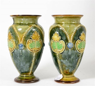 Lot 125 - A pair of Doulton Lambeth flower vases, 17.5cm high