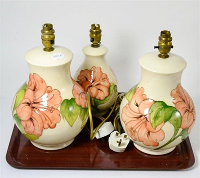 Lot 179 - A graduated set of three Moorcroft pottery table lamps