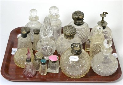 Lot 181 - A tray of cut glass scent bottles, some with silver mounts and covers