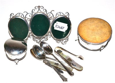 Lot 1 - A silver triple photograph frame, two silver boxes, two silver and mother-of-pearl letter...