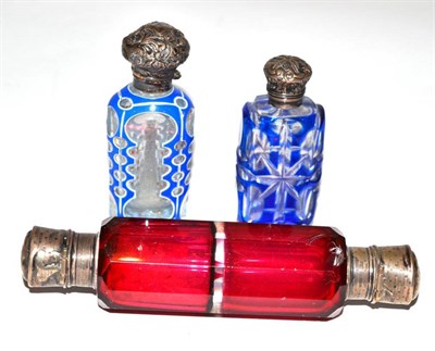 Lot 23 - A Victorian cranberry double scent and two blue flashed glass scent bottles (3)