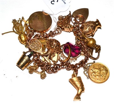 Lot 30 - A gold charm bracelet hung with twenty one charms including 1903 gold sovereign