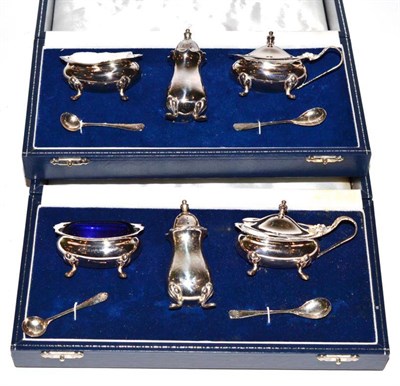 Lot 51 - Two silver three piece condiment sets, with spoons, in cases