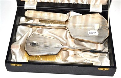 Lot 72 - A cased silver mounted dressing table set