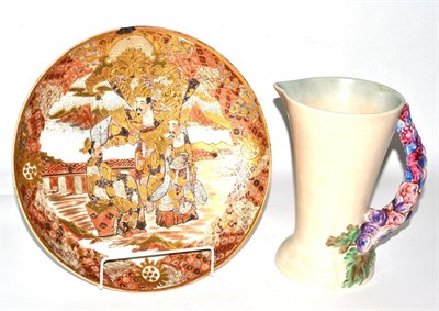 Lot 82 - A Japanese Satsuma charger, Meiji period, floral design, and a Clarice Cliff jug with floral handle