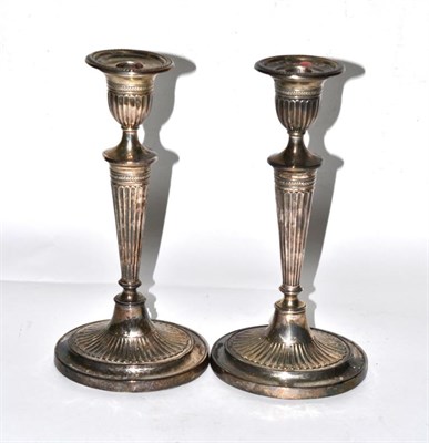 Lot 84 - A pair of loaded silver candlesticks