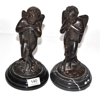 Lot 140 - A pair of bronze cherubs, 20th century, on marble plinth bases (2)