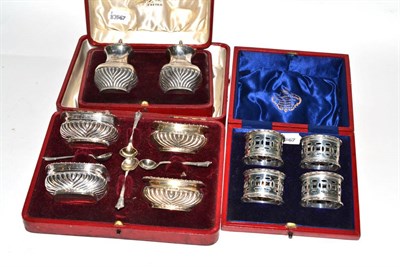 Lot 154 - A cased set of four silver salts, a cased pair of silver pepperettes and a cased set of four napkin