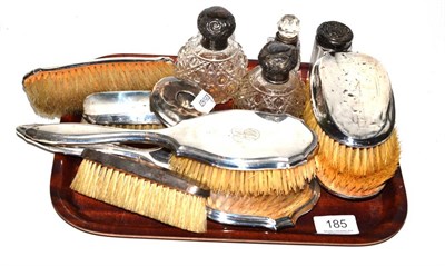 Lot 185 - Four silver topped dressing table jars, six silver backed brushes and a silver backed hand...