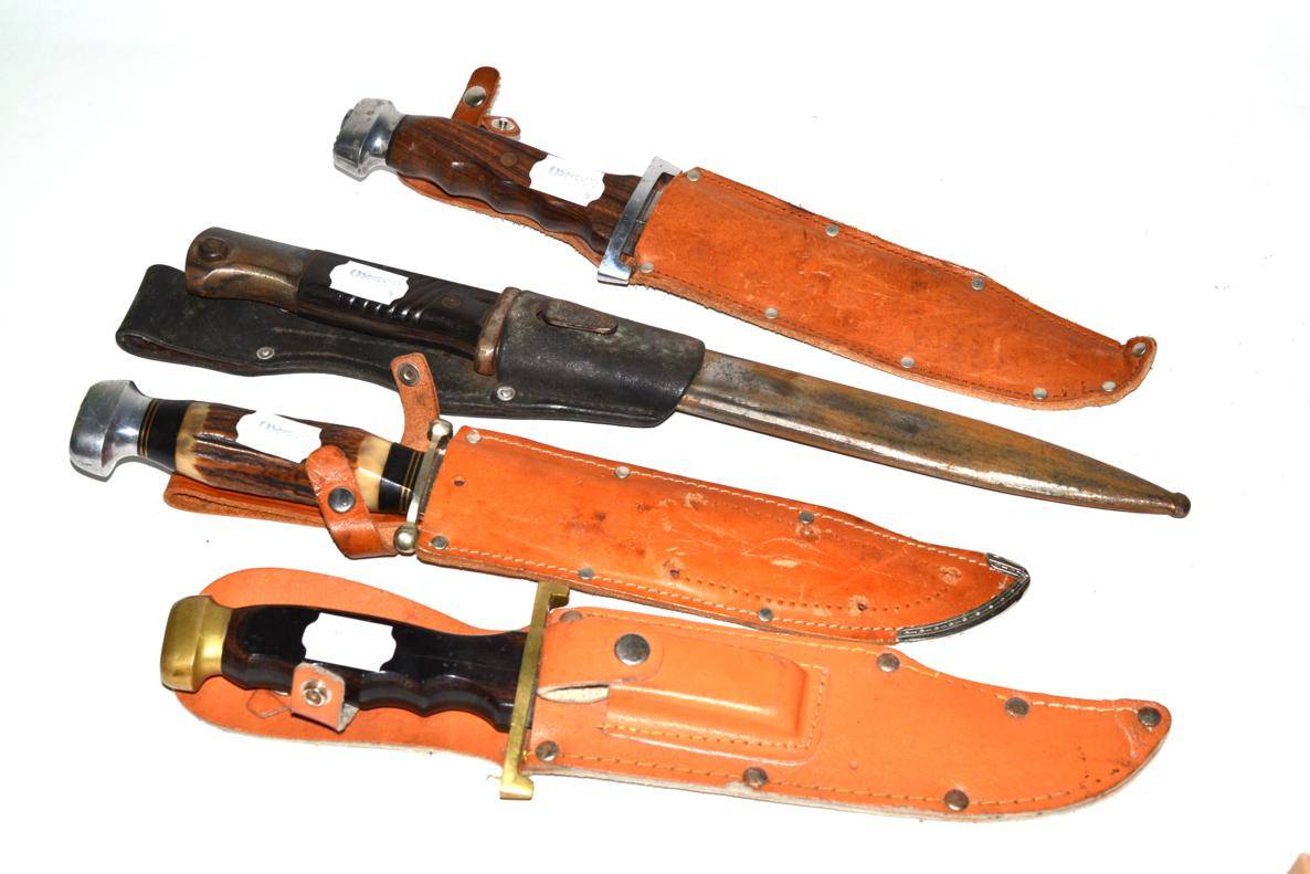 Lot 234 - Second World War German bayonet and scabbard and three hunting knives with solingen blades, leather