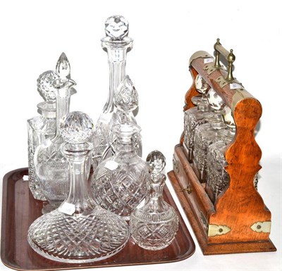 Lot 244 - A Victorian oak three decanter tantalus and six other cut crystal decanters and similar