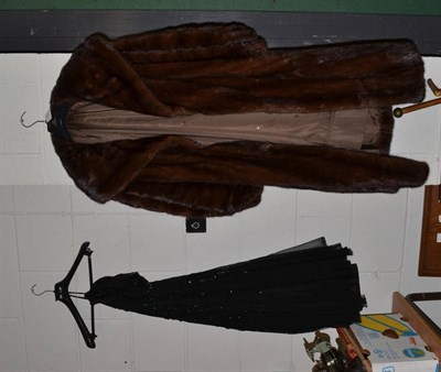 Lot 365 - A brown mink fur coat with shawl type collar and cuffed sleeves, and a black net strapless...