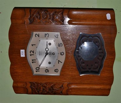 Lot 434 - An oak cased chiming wall clock