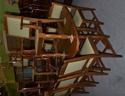 Lot 462 - An oak trestle base dining table together with a set of eight chairs (including two carvers)