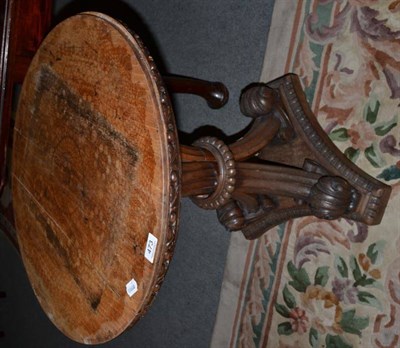 Lot 473 - A 19th century tripod table raised on boldly carved acanthus leaf legs and a triform platform base