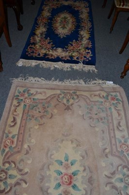 Lot 488 - A Chinese carved rug of Savonnerie design, the pale mushroom field with floral central panel...