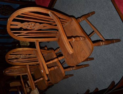 Lot 496 - A set of three elm Windsor chairs