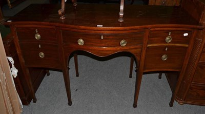 Lot 506 - A mahogany serpentine front sideboard in Georgian style