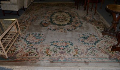 Lot 547 - A Chinese carved carpet of Savonnerie design, the mushroom field centred by a floral panel...