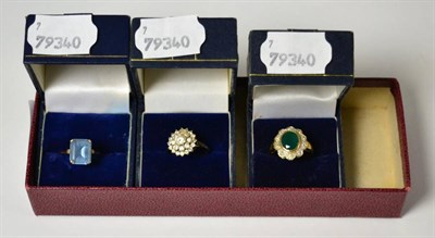 Lot 1 - A group of three dress rings; one stamped 375 and set with CZ's, one stamped 375 and one other