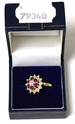Lot 25 - A 9ct gold flower head cluster ring set with red and clear stones