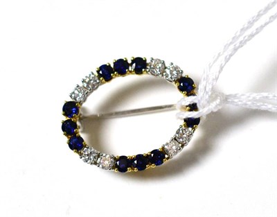 Lot 57 - An 18ct gold sapphire and diamond hoop brooch, pairs of round brilliant cut diamonds alternate with