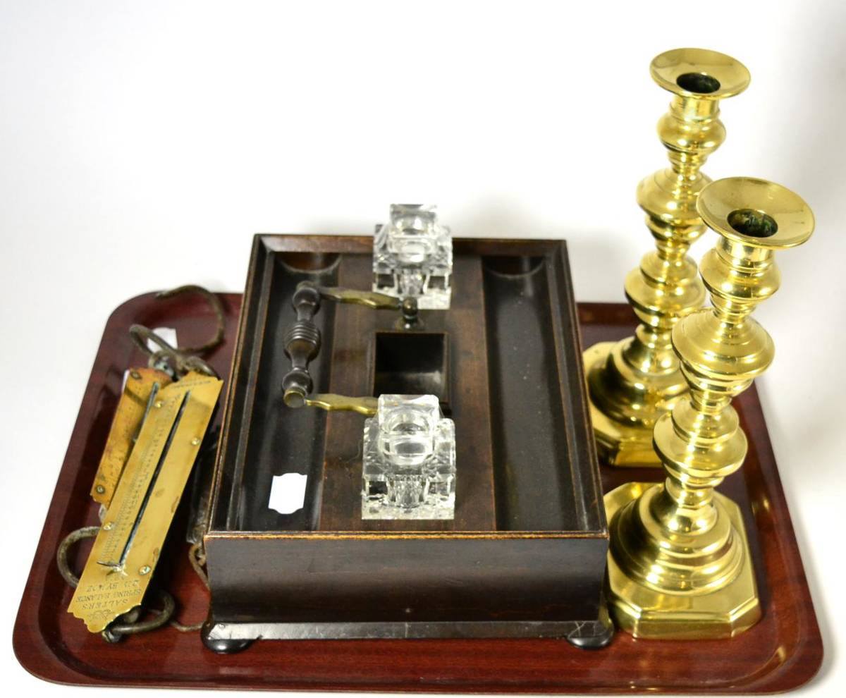 Lot 95 - A mahogany ink stand, three spring balances and a pair of brass candlesticks