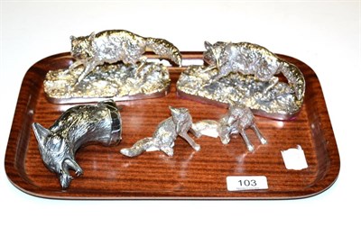Lot 103 - A silver fox head car mascot, two white metal models of foxes on plinth bases and two free standing
