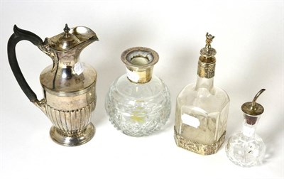 Lot 106 - A silver hot water jug, a Continental liqueur bottle, silver mounted dressing table jar lacking...