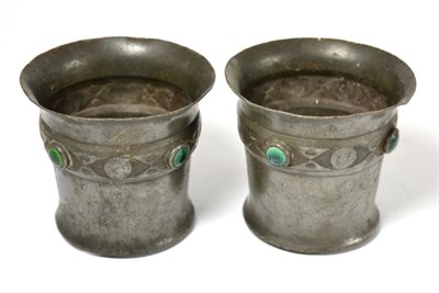 Lot 136 - A pair of early 20th century pewter vessels inset with Ruskin type blue and green enamel...