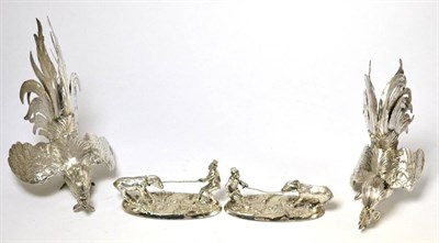 Lot 145 - A pair of white metal cocks and two silver plated models of a man and donkey