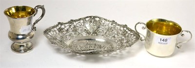 Lot 148 - A Continental pierced silver oval dish, chased with scrolls, flowers and figures, a silver twin...