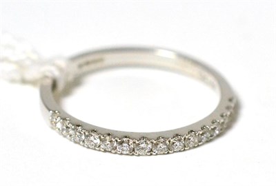 Lot 159 - An 18ct white gold diamond half hoop ring, round brilliant cut diamonds in white claw settings on a