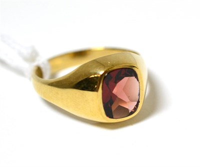 Lot 160 - A 9ct gold garnet signet ring, the cushion cut fancy shaped garnet in a yellow rubbed over...