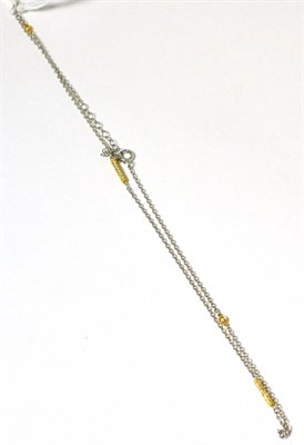 Lot 161 - A diamond necklace, a white trace link chain, set with diamonds in yellow mounts, total...