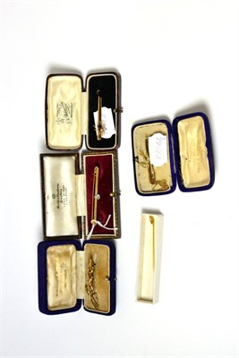 Lot 165 - A diamond set bar brooch, a spider bar brooch, a swallow brooch, another brooch and a stick pin