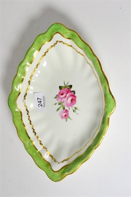 Lot 247 - A lozenge shape dessert dish, painted with pink roses within a green and gilt border, painted...