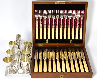 Lot 250 - A cased set of twelve Victorian silver plated fruit eaters and a silver plated egg cruet