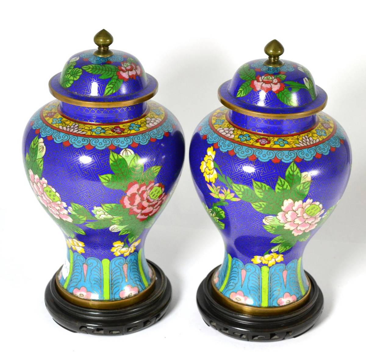 Lot 255 - A pair of Chinese cloisonne enamel vases and covers with hardwood stands