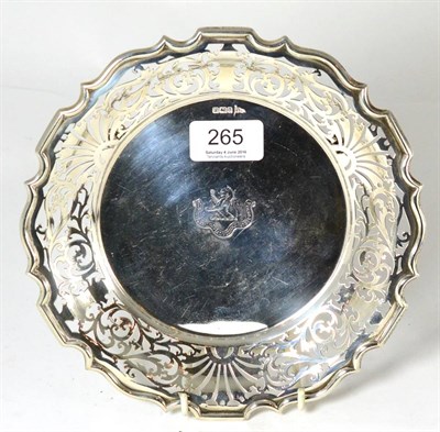 Lot 265 - A Walker & Hall silver dish with pierced rim and raised on three feet, engraved with a crest