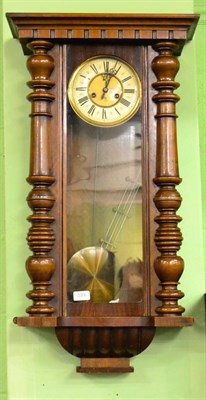 Lot 333 - A walnut Vienna style wall clock by Gustav Becker, with pendulum and key